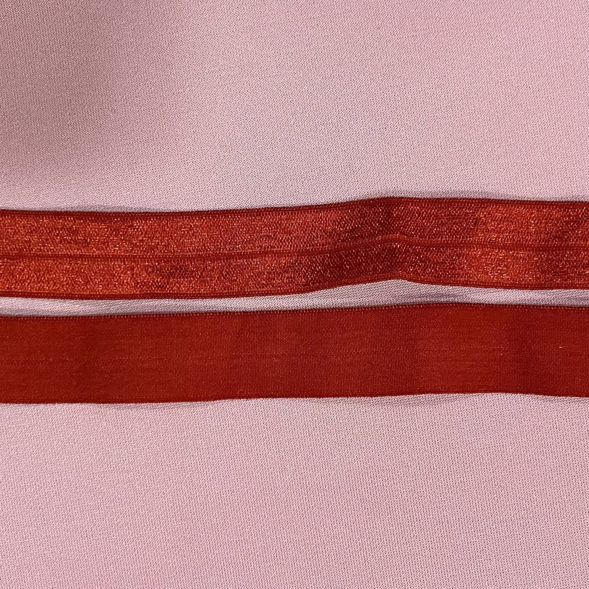 Red Fold Over Elastic on a Pink Background