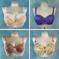 Four bras on mannequins with different designs and colors against a blue background