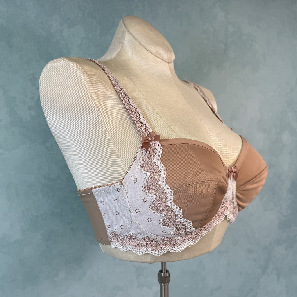 Brown bra with lace details on a mannequin against a gray background
